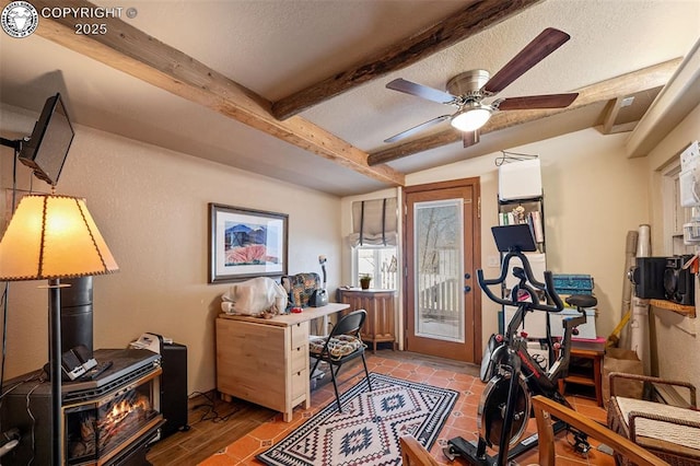 office featuring a textured ceiling, beam ceiling, and a ceiling fan