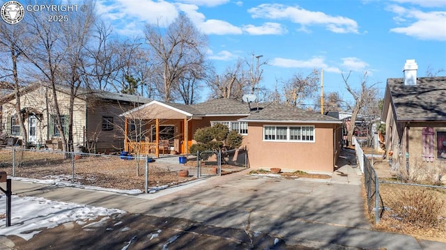 ranch-style home with a gate, fence private yard, and stucco siding