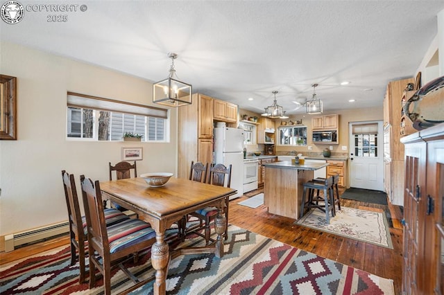 dining space featuring dark wood-style floors, recessed lighting, a chandelier, and baseboard heating