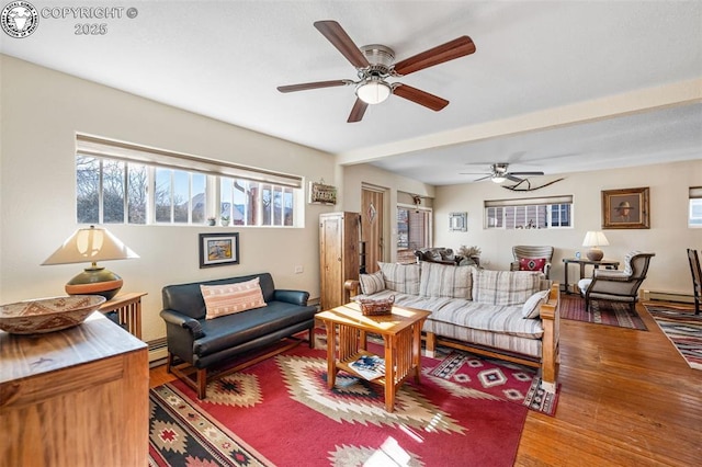 living room featuring a baseboard radiator, ceiling fan, baseboard heating, and wood finished floors