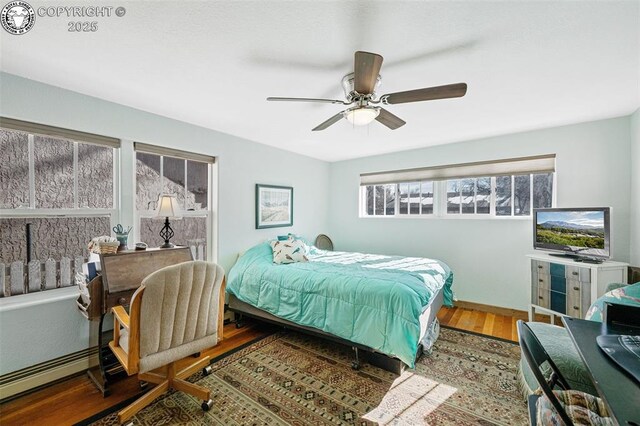 bedroom with a ceiling fan and wood finished floors