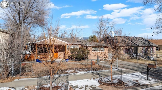 yard covered in snow with driveway and fence