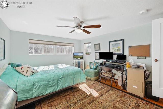 bedroom with ceiling fan and wood finished floors