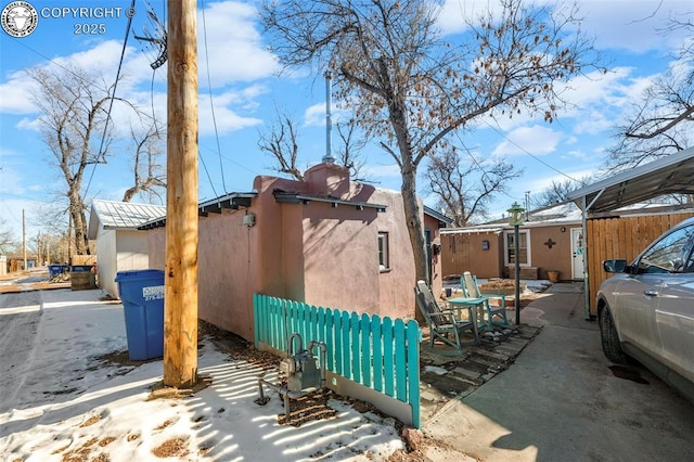 view of property exterior with fence and stucco siding