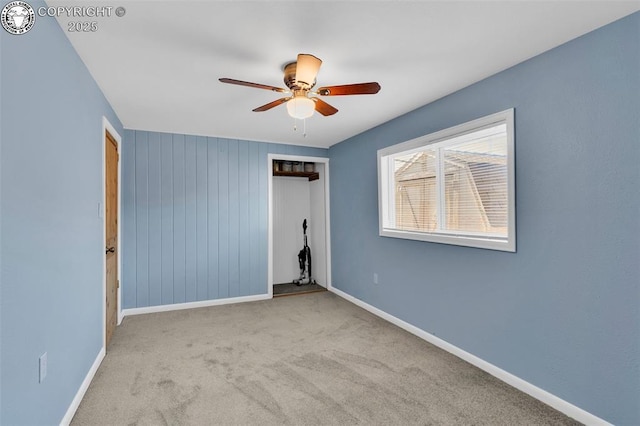 unfurnished bedroom with light colored carpet, a closet, and ceiling fan