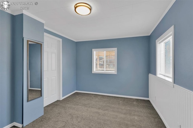 unfurnished bedroom featuring crown molding and light colored carpet