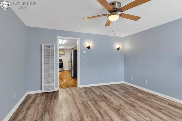 empty room featuring ceiling fan and light hardwood / wood-style floors