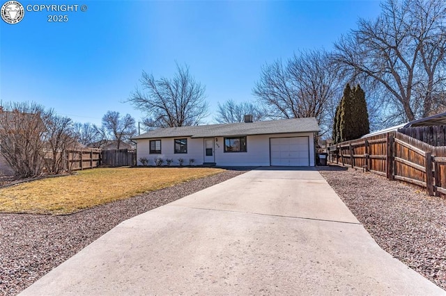 ranch-style home with an attached garage, fence, a front lawn, and concrete driveway