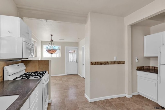 kitchen featuring white cabinetry, sink, white appliances, and pendant lighting