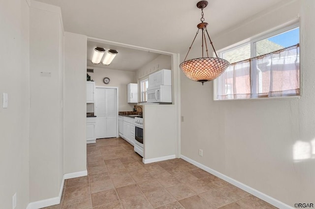 kitchen with white cabinetry, white appliances, sink, and pendant lighting