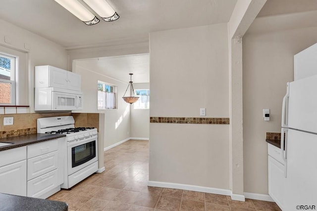 kitchen featuring white cabinetry, white appliances, decorative light fixtures, and light tile patterned floors