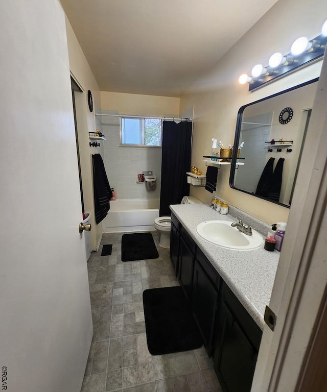 full bathroom with vanity, shower / tub combo, and toilet