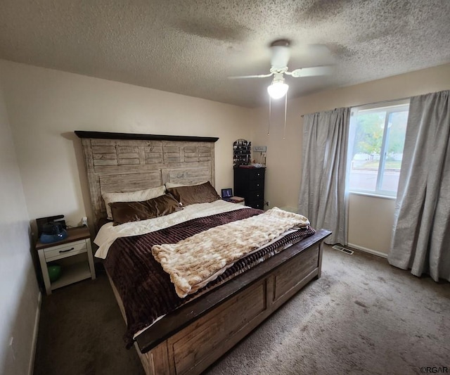 carpeted bedroom with ceiling fan and a textured ceiling