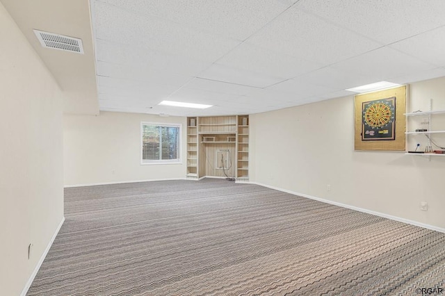 basement featuring carpet flooring and a drop ceiling