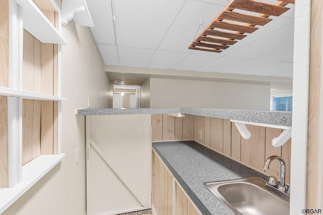 kitchen featuring sink and a paneled ceiling