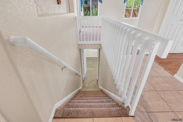 stairs featuring tile patterned flooring