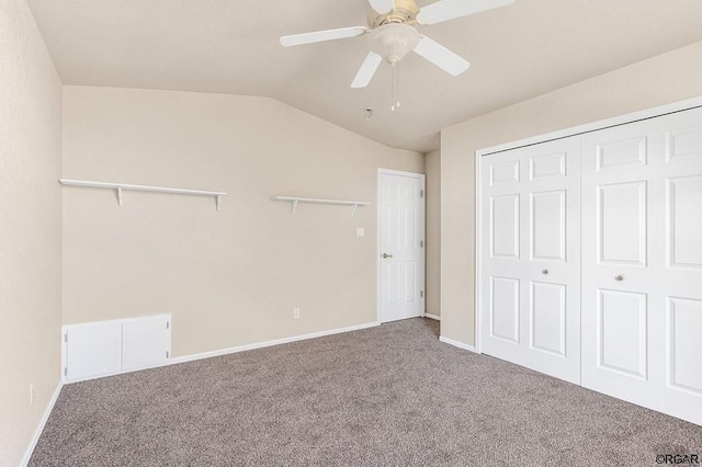 unfurnished bedroom featuring carpet, lofted ceiling, ceiling fan, and a closet