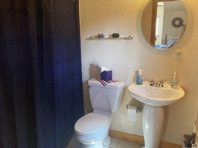 bathroom with tile patterned flooring and toilet