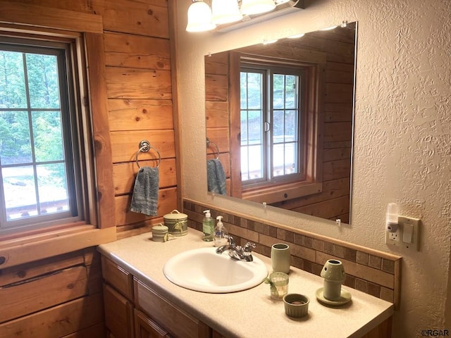 bathroom featuring tasteful backsplash, vanity, and plenty of natural light