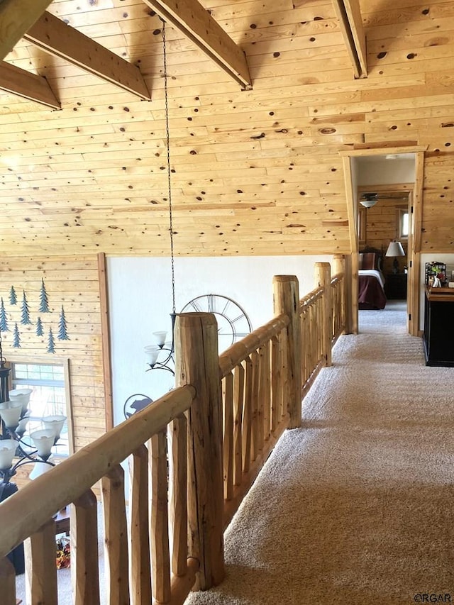 hall featuring beamed ceiling, carpet flooring, wood ceiling, and high vaulted ceiling