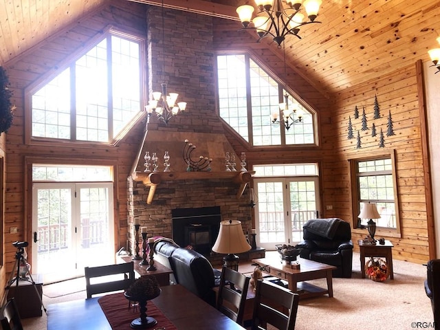 living room featuring high vaulted ceiling, a chandelier, and french doors