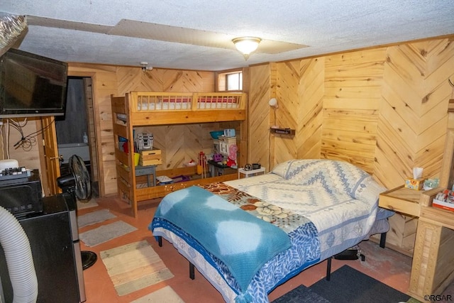 bedroom with a textured ceiling and wood walls