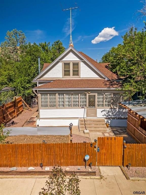 back of property with a fenced front yard