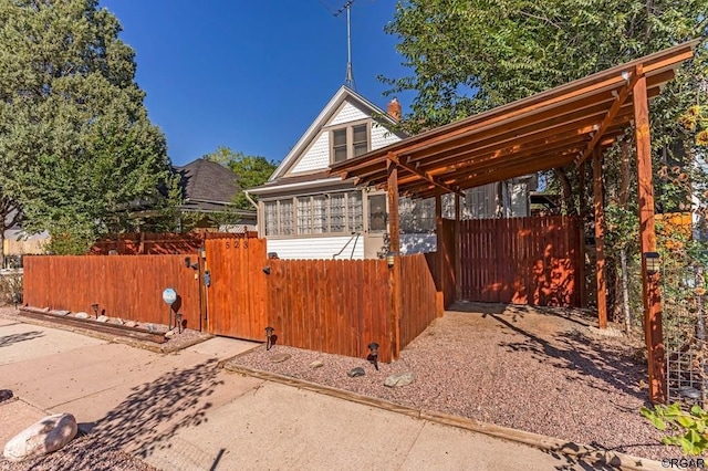 exterior space with a fenced front yard and a gate