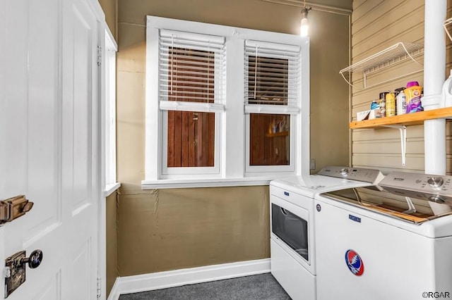 washroom with laundry area, baseboards, and separate washer and dryer