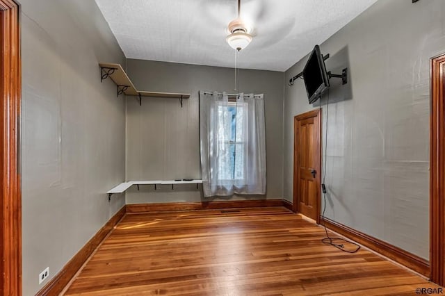 unfurnished dining area featuring baseboards and wood finished floors