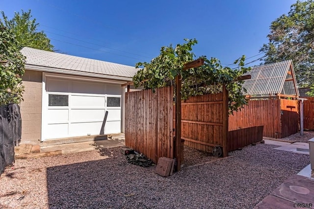 view of yard with fence and an outdoor structure