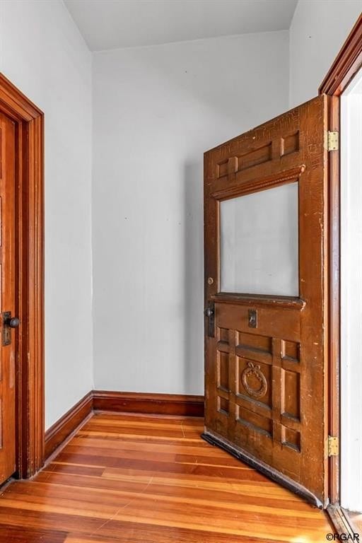 interior space with wood finished floors and baseboards