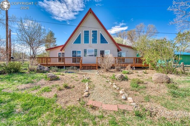 rear view of property featuring a deck