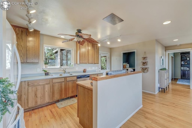 kitchen with a center island, freestanding refrigerator, a sink, and rail lighting