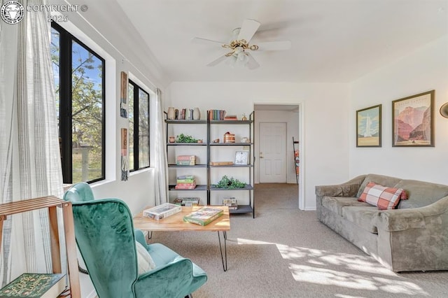 interior space with a ceiling fan and carpet