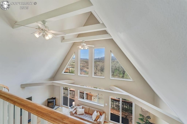 additional living space with a ceiling fan and lofted ceiling with beams
