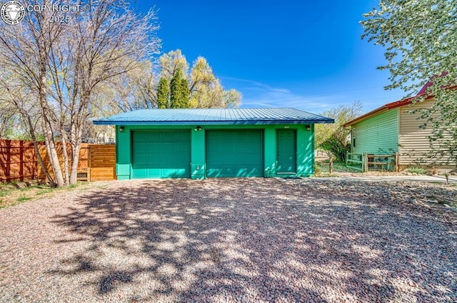 detached garage featuring fence