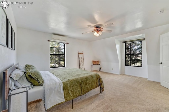 bedroom featuring carpet flooring, ceiling fan, an AC wall unit, and baseboards