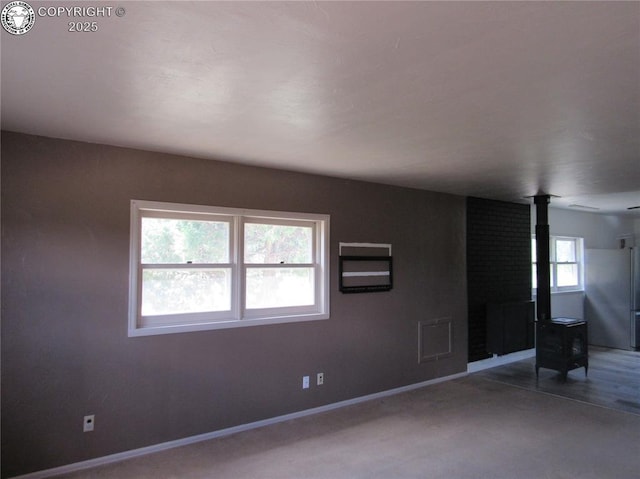 855 Ernest Ave, Westcliffe, CO 81252 - spare room featuring a wood stove and baseboards