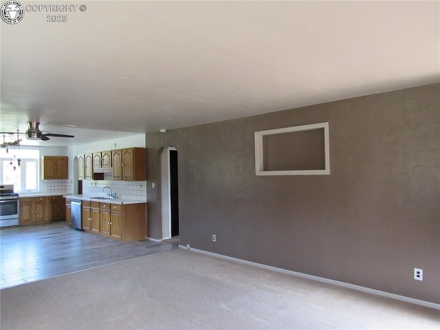 855 Ernest Ave, Westcliffe, CO 81252 - kitchen featuring stainless steel appliances, light countertops, a ceiling fan, brown cabinets, and arched walkways