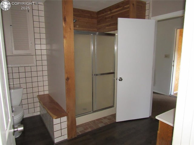 855 Ernest Ave, Westcliffe, CO 81252 - bathroom featuring a stall shower, vanity, tile walls, and wood finished floors