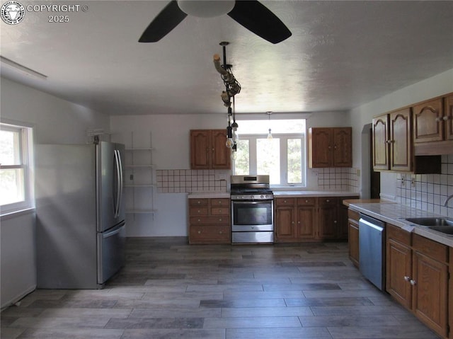 855 Ernest Ave, Westcliffe, CO 81252 - kitchen with stainless steel appliances, ceiling fan, tasteful backsplash, light countertops, and brown cabinets