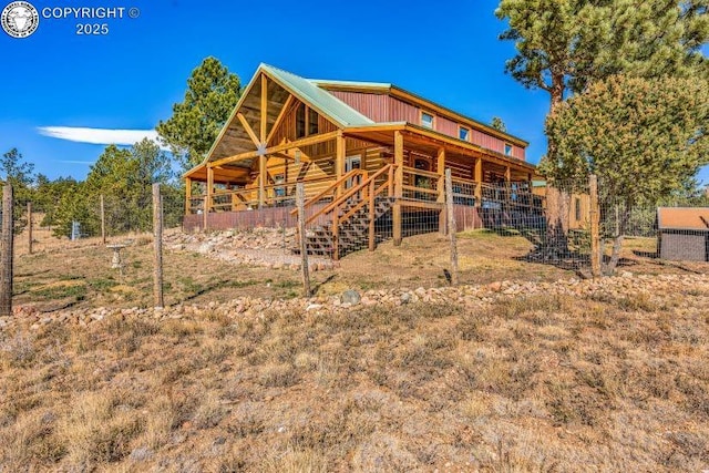 back of property featuring an outdoor structure