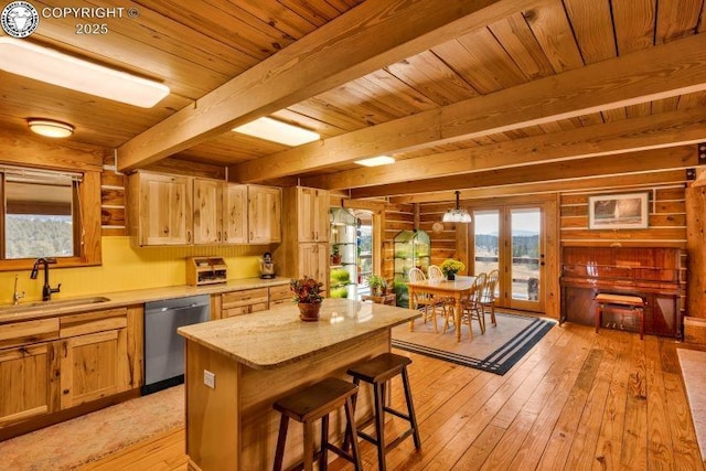 kitchen featuring sink, a center island, dishwasher, beamed ceiling, and light hardwood / wood-style floors