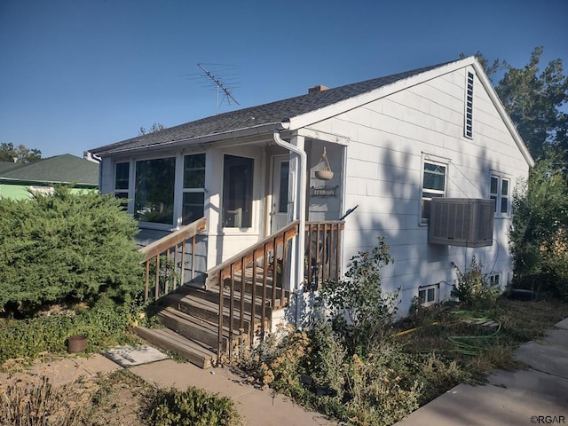 view of front of house featuring cooling unit