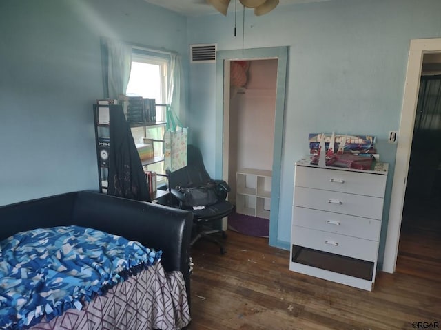 bedroom with a closet and dark hardwood / wood-style floors