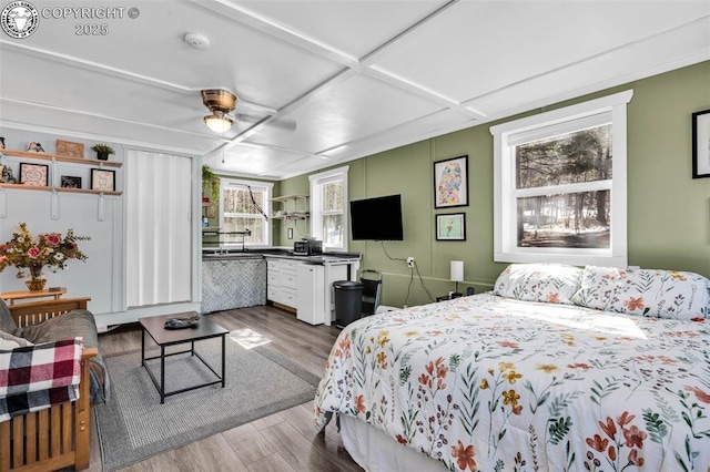 bedroom with ceiling fan and dark wood-style flooring