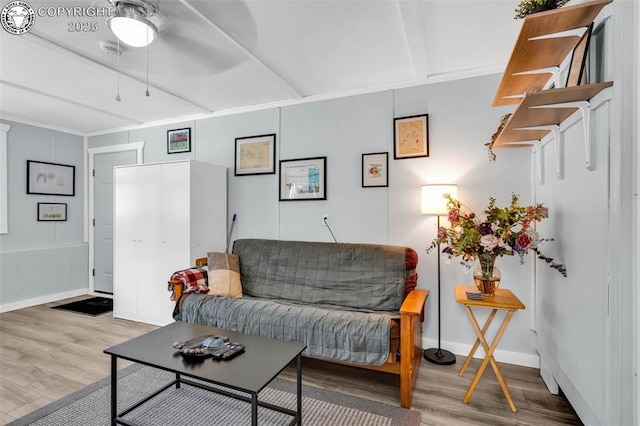 living area featuring baseboards and wood finished floors