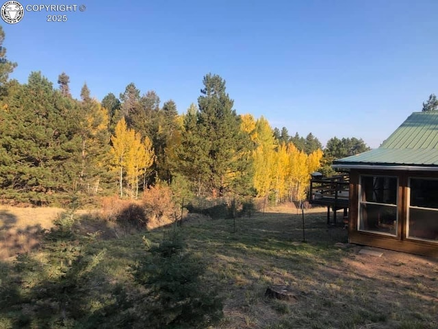 view of yard with a view of trees