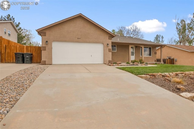 ranch-style house featuring driveway, a front yard, fence, an attached garage, and stucco siding